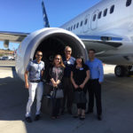 BlackWing team members, Mitch Sieber, Stephanie Cooper, Gary Meyers, Gina Markovich, and Charlie Worcester, in front of one of the new airplane’s engines.